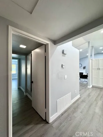 a view of a hallway with wooden floor