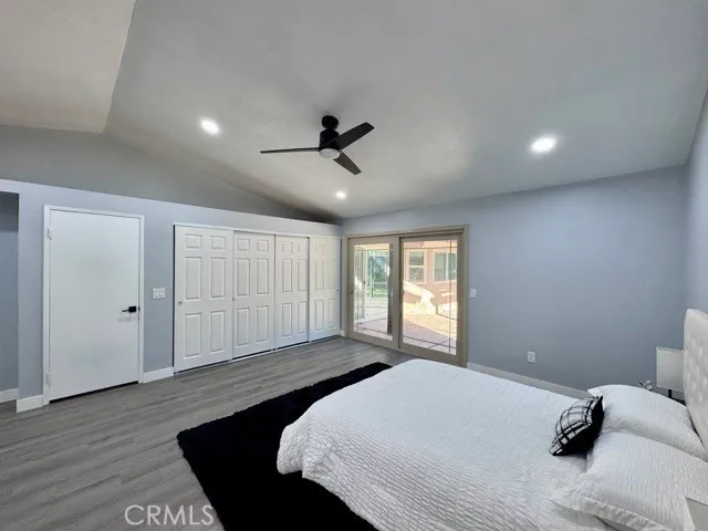 a bedroom with a large bed and a ceiling fan