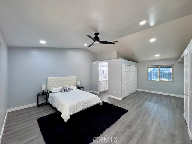 a bedroom with a bed and a ceiling fan