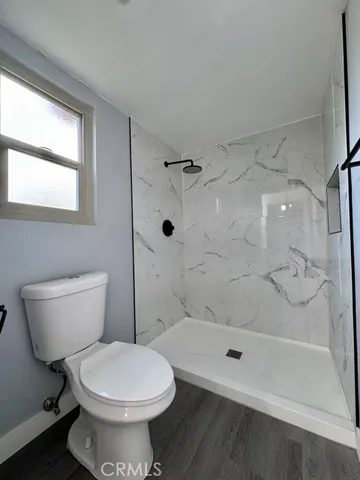 a bathroom with a toilet and shower