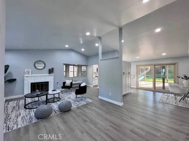 a living room with furniture wooden floor and a fireplace