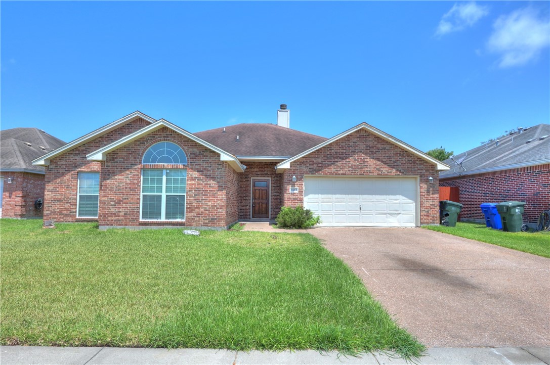 a front view of a house with a yard and garage