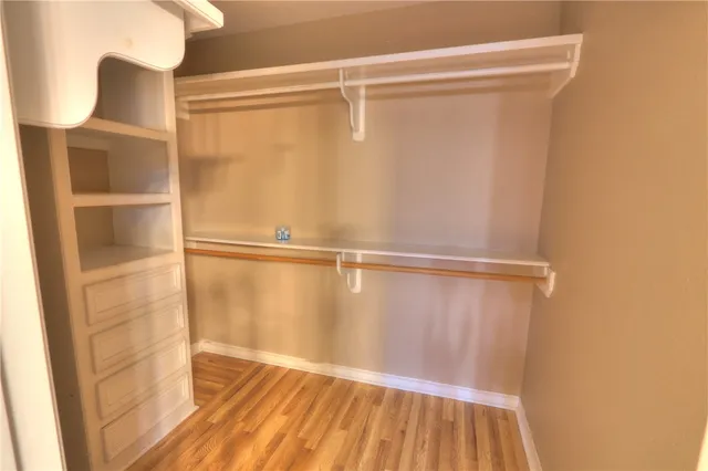 a view of a hallway with an empty room and fire place