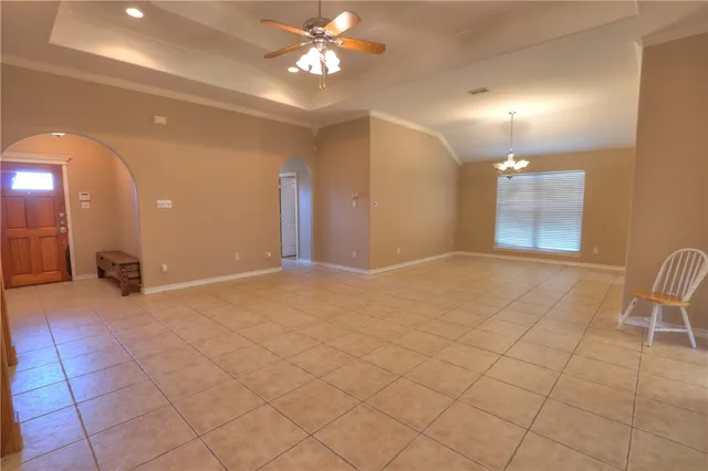 a view of an empty room with a chandelier
