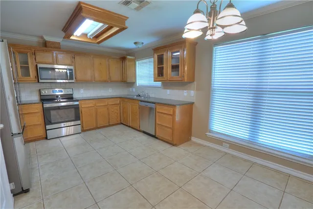 a large kitchen with cabinets and stainless steel appliances