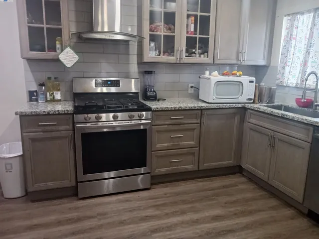 a kitchen with stainless steel appliances granite countertop a stove and a sink