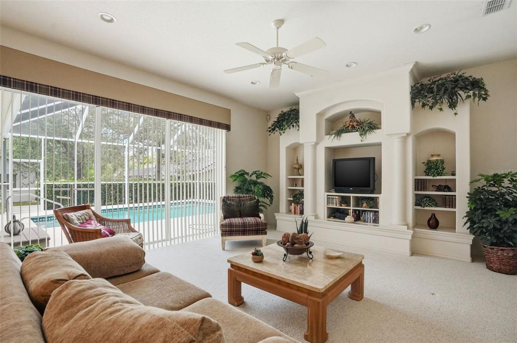 7221 Aloe Drive Spring Hill, FL 34607 - Photo 11 of 34 a living room with furniture a flat screen tv and a large window