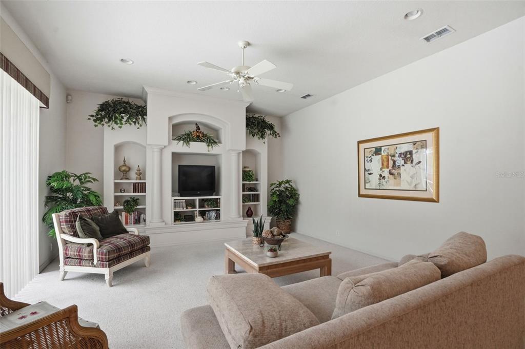 7221 Aloe Drive Spring Hill, FL 34607 - Photo 12 of 34 a living room with furniture and a fireplace
