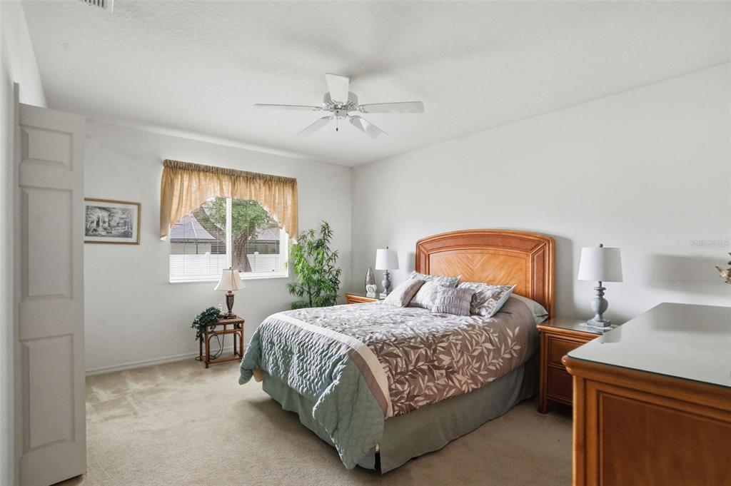 7221 Aloe Drive Spring Hill, FL 34607 - Photo 19 of 34 a bedroom with a bed a lamp and window