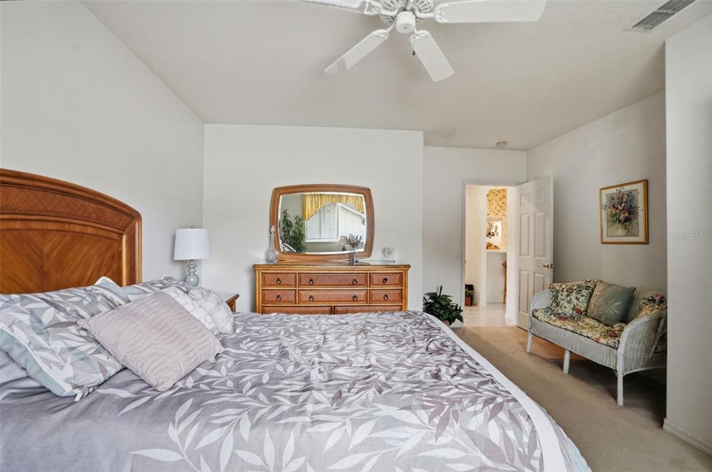 7221 Aloe Drive Spring Hill, FL 34607 - Photo 20 of 34 a bedroom with a large bed and a couch