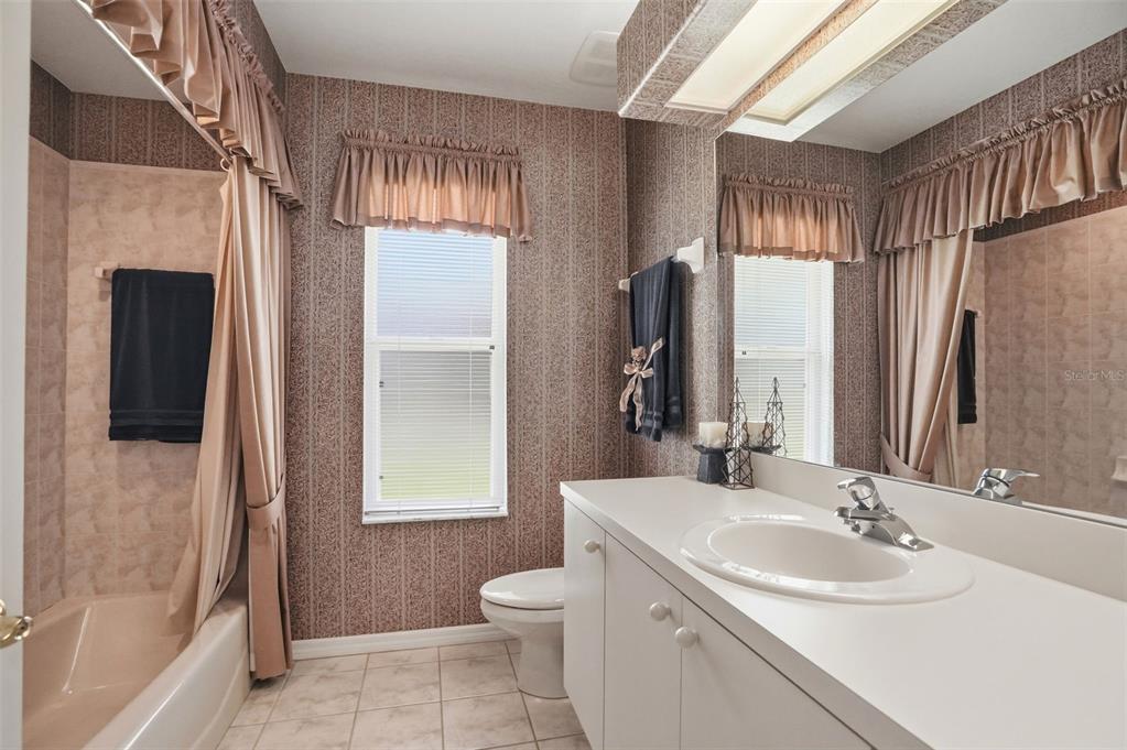 7221 Aloe Drive Spring Hill, FL 34607 - Photo 22 of 34 a bathroom with a sink toilet and shower