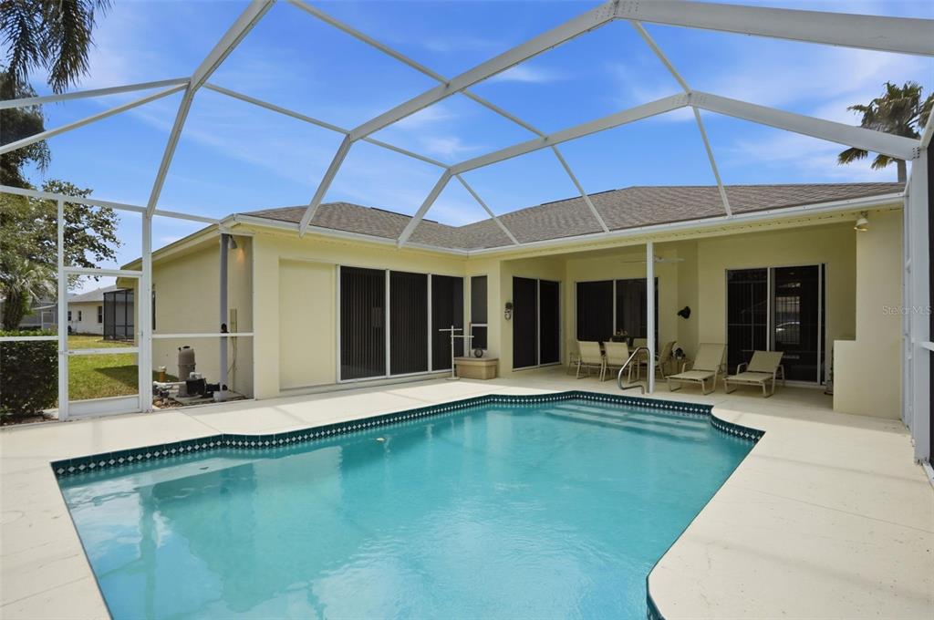 7221 Aloe Drive Spring Hill, FL 34607 - Photo 27 of 34 a swimming pool with patio outdoor seating and yard