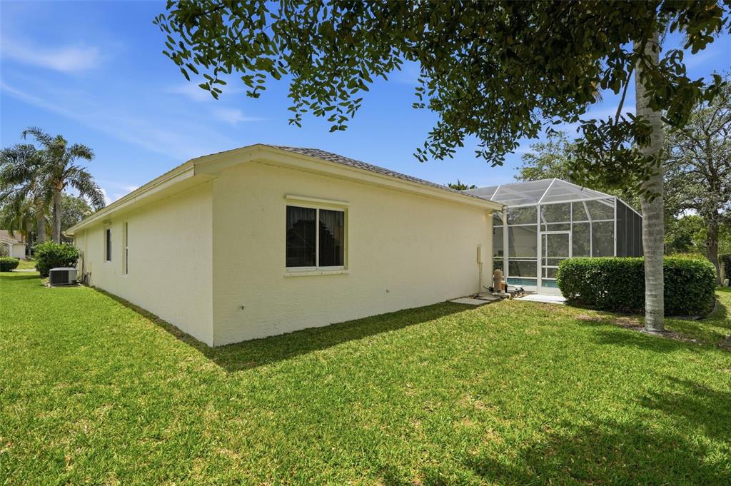 7221 Aloe Drive Spring Hill, FL 34607 - Photo 30 of 34 a view of a white house with a big yard