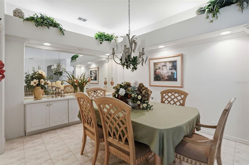 7221 Aloe Drive Spring Hill, FL 34607 - Photo 6 of 34 a view of a dining room with furniture and chandelier