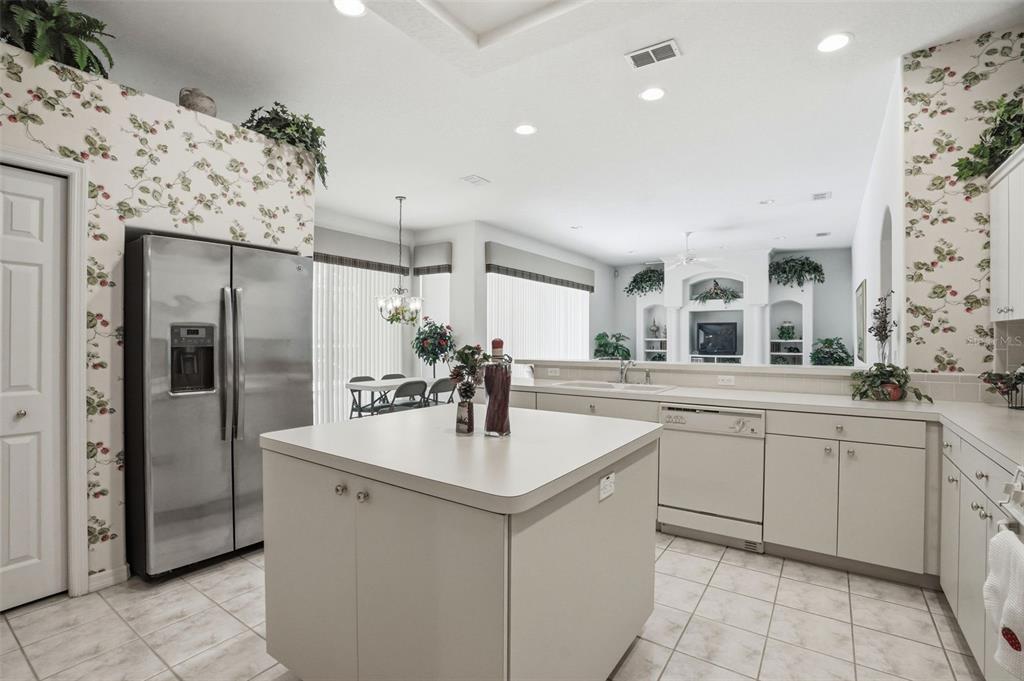 7221 Aloe Drive Spring Hill, FL 34607 - Photo 7 of 34 a kitchen with stainless steel appliances a sink stove and refrigerator