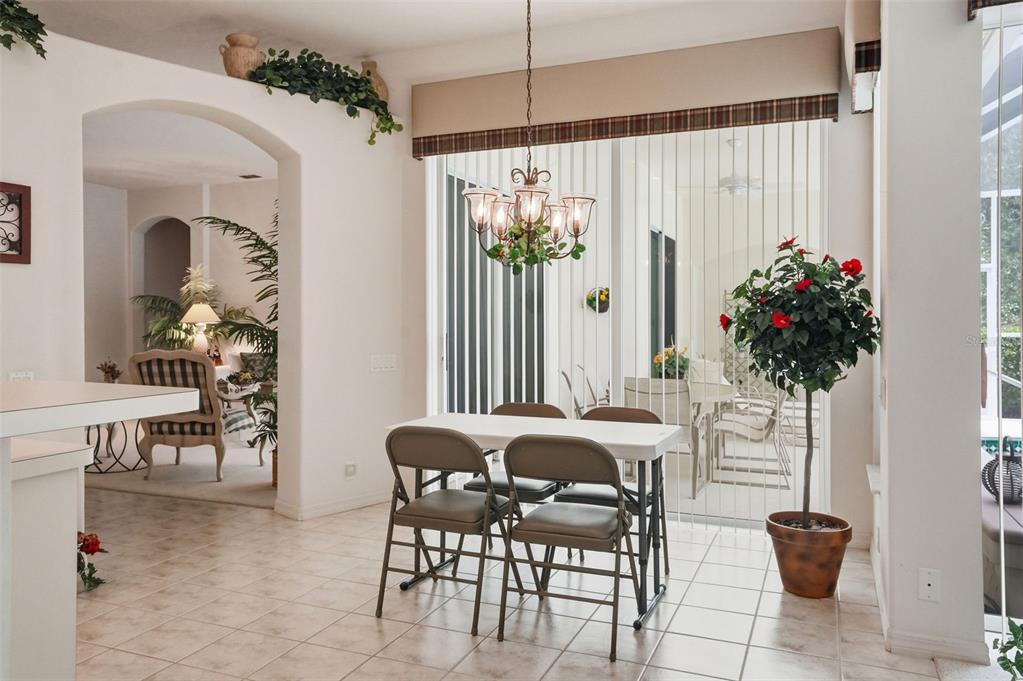 7221 Aloe Drive Spring Hill, FL 34607 - Photo 10 of 34 a view of a dining room with furniture and chandelier