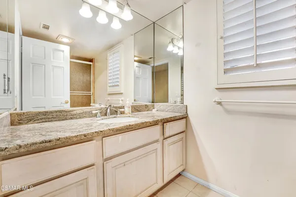 a bathroom with a glass shower door