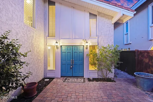 a view of a house with potted plants