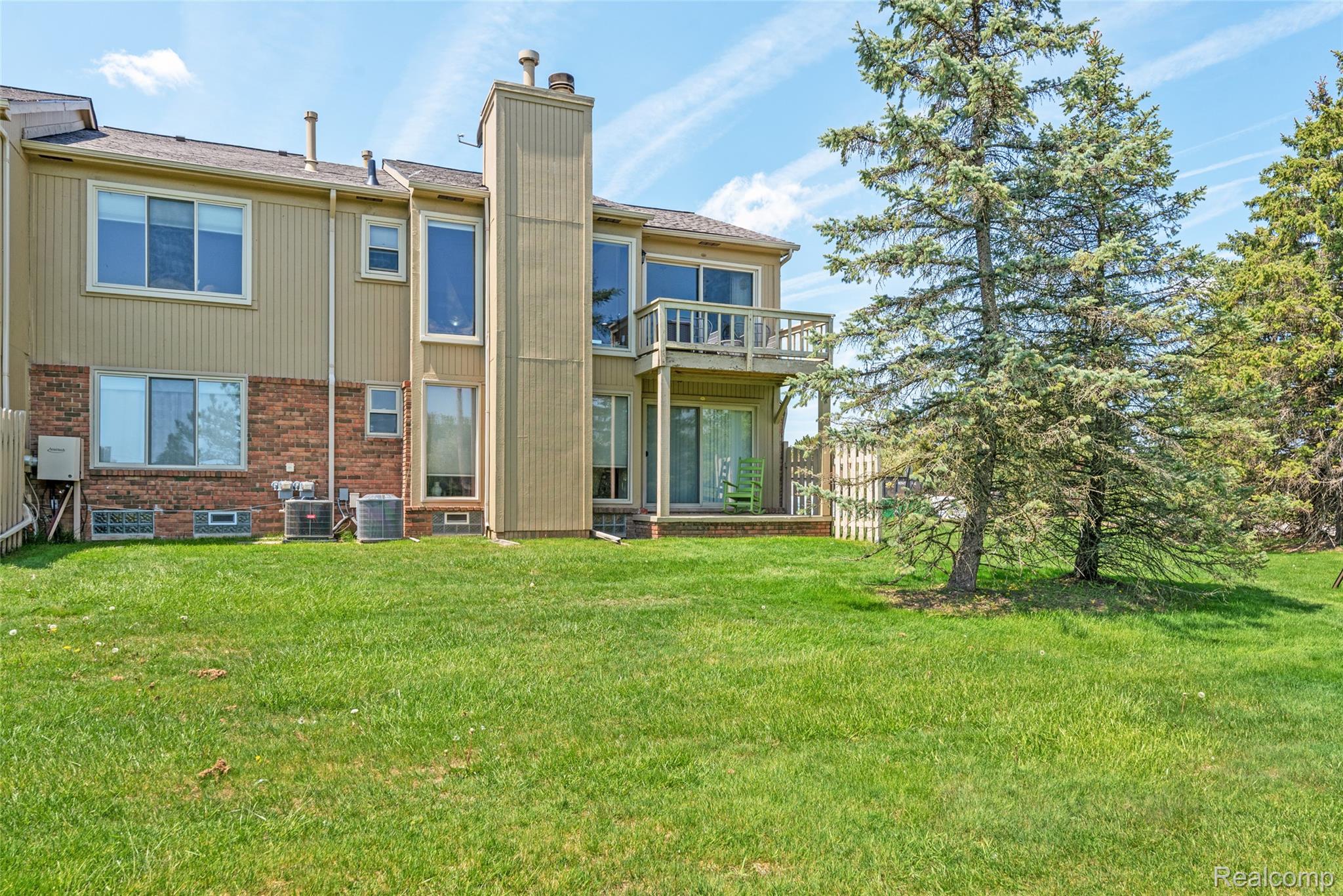700 Tennyson Rochester, MI 48307 - Photo 23 of 32 Back of property with brick siding, a chimney, and a balcony