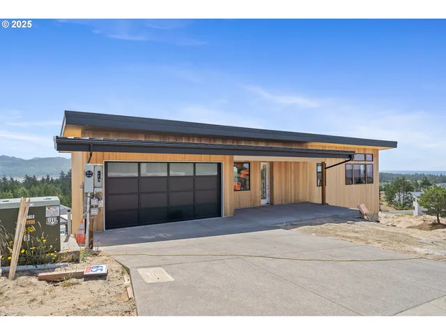 a view of house with garage and chair