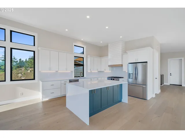 a view of an empty room with wooden floor and a floor to ceiling window