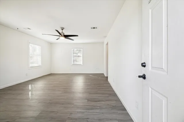 a view of room with window and wooden floor
