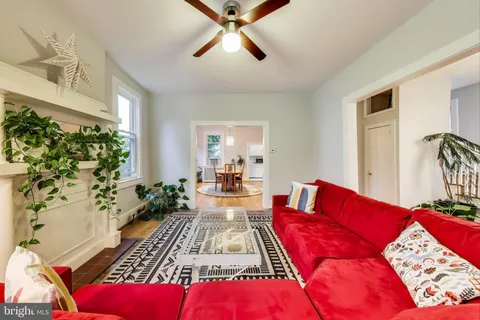 a living room with furniture a bed and a chandelier