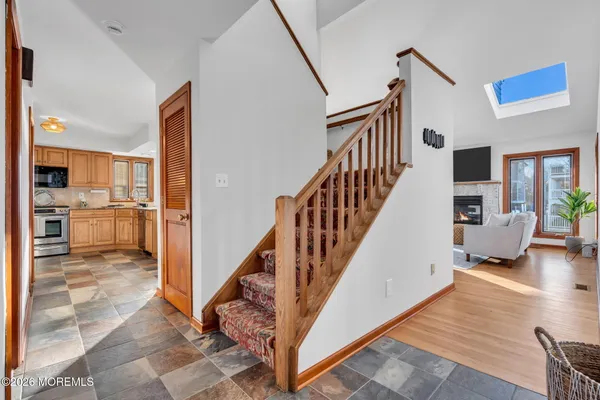 a view of entryway and hall with wooden floor