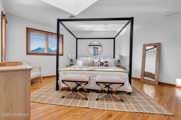 a dining room with wooden floor and large window