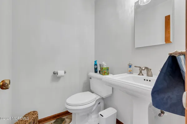 a white toilet sitting next to a white sink