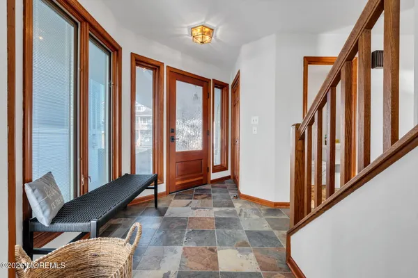 a view of a hallway with furniture and entryway