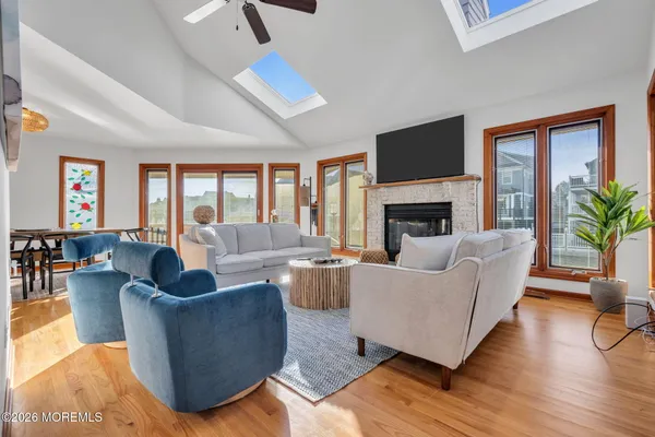 a living room with fireplace furniture and a large window