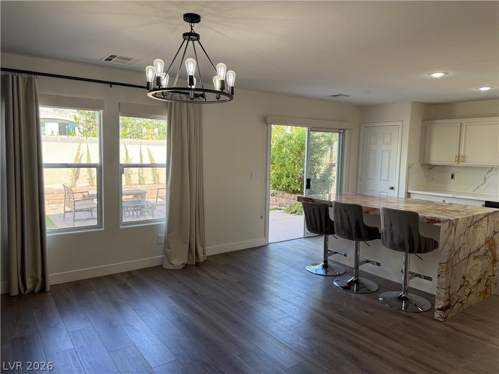 1141 Cathedral Ridge Street Henderson, NV 89052 - Photo 33 of 77 This kitchen and dining area features a large island, wood flooring, and a sliding door to the outdoor patio.