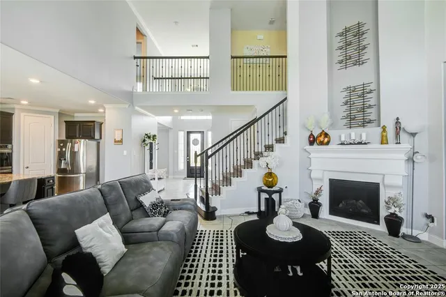 a kitchen with stainless steel appliances granite countertop wooden cabinets a refrigerator and a sink