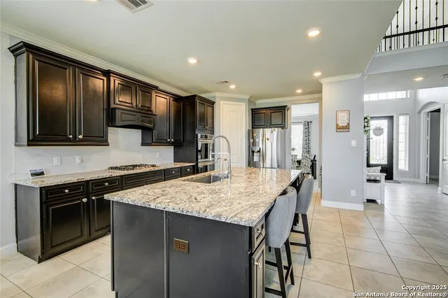 a kitchen with a stove a sink and a refrigerator