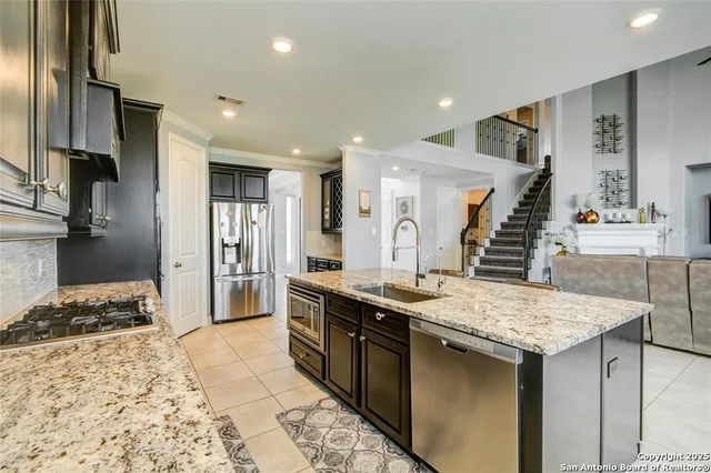 a kitchen with granite countertop a stove and a sink