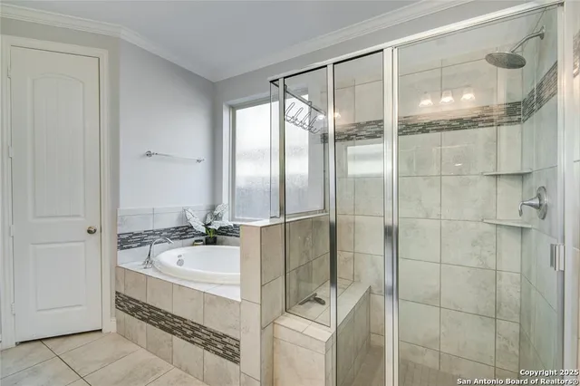 a spacious bathroom with a tub and a shower