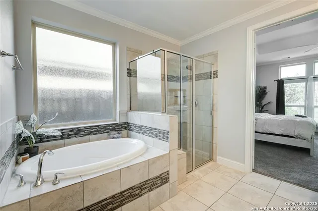 a spacious bathroom with a granite countertop tub sink and mirror
