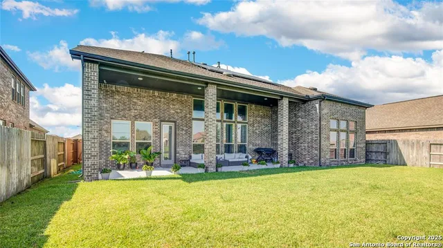 a living room with furniture and floor to ceiling windows