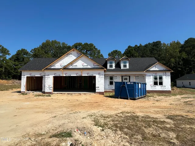 a view of house with yard and covered with snow in front of house