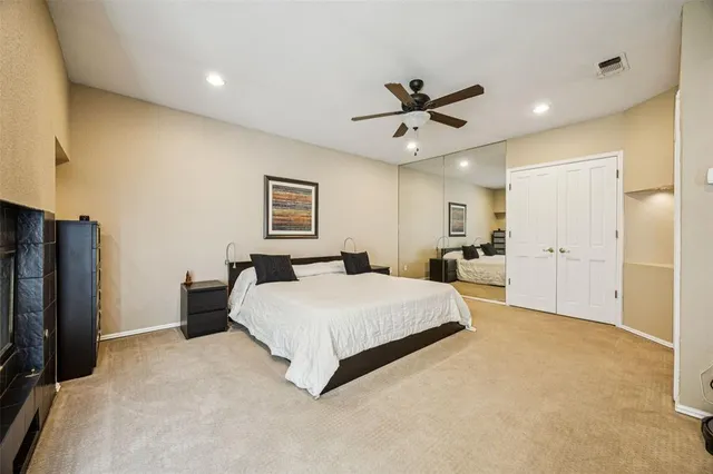 a spacious bedroom with a bed and a chandelier