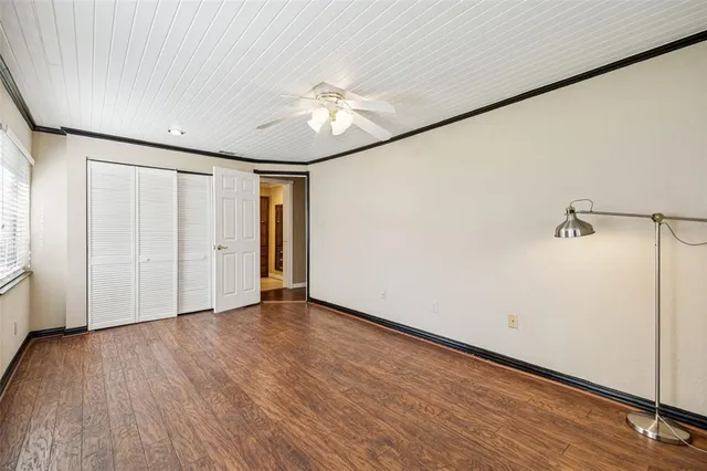 a view of an empty room with wooden floor