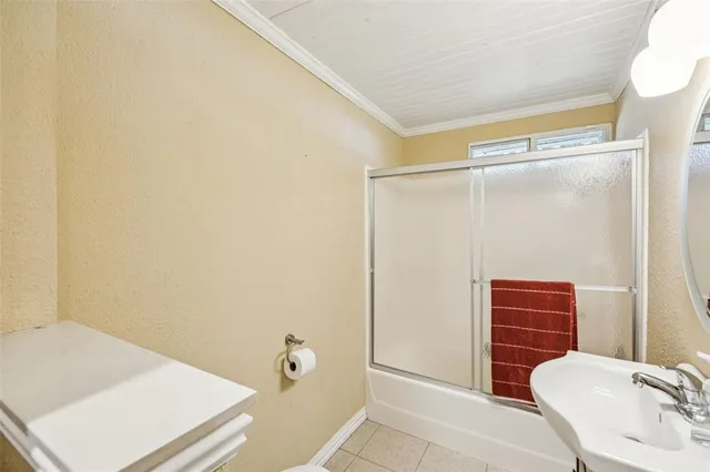 a bathroom with a shower and a sink