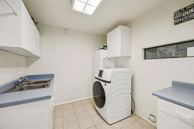 a kitchen with a sink and a stove top oven