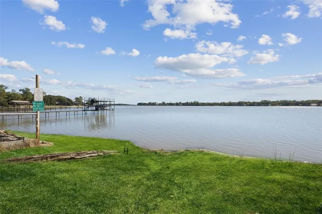 a view of a lake with houses in the back