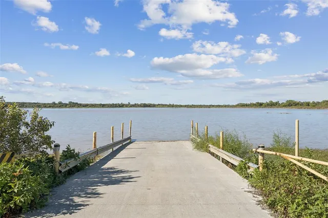 a view of a lake with houses in the back