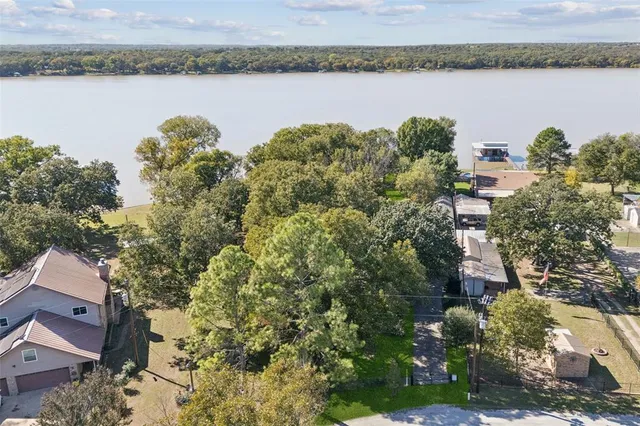 an aerial view of a house with lake view