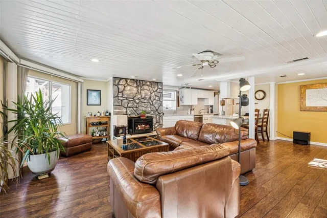 a living room with furniture potted plant and a window