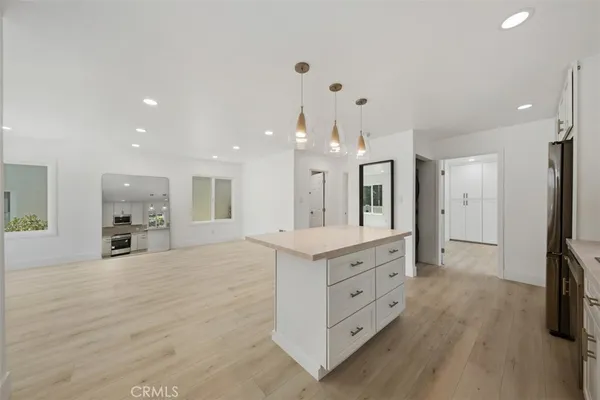 a large bathroom with a large mirror vanity and shower