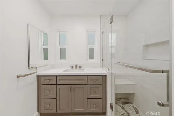 a bathroom with double sink and a mirror